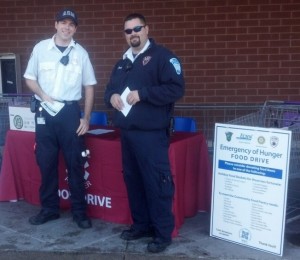 Kyle Caldwell, left, and Dave Tedeschi, emergency medical technicians with Ambulance Service of Manchester, at the 2013 Emergency of Hunger Food Drive.