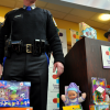 Toy Drive Organizer and State Police Sergeant stands by some of the yield