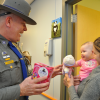 Connecticut State Trooper offers a toy to a young patient (photo with permission)
